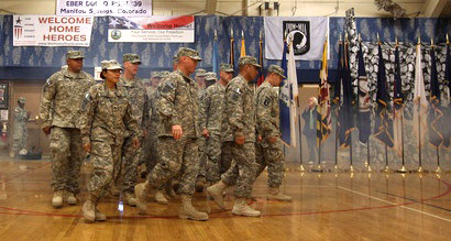 Troops return a - Marching in